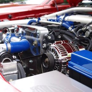 Detailed view of a clean modern car engine with vibrant colored components and sleek design.
